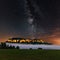 Night view of the Milky Way above the illuminated Koenigstein Fortress. The enlightened Konigstein fortress and the fog in