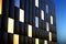 Night view of modern building exterior front wall with glowing windows