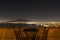 Night view of Mt Vesuvius from balcony with table and chairs, Pompeii