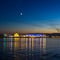 Night view of Nizhny Novgorod from the Volga River, a church, a bridge with a Russian city with illumination