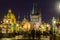 Night view of  Old Town Bridge Tower and background of  Church of St Francis Seraph at the bank of River Vltava, view from the