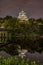 Night view of Osaka castle reflecting in water moat in Osaka, Japan