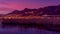 Night view of reeds, lights in the city, bridge and mountain. Cityscape. Villeneuve. Switzerland.