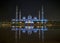 A night view of Sheikh Zayed Grand Mosque from a water reflection