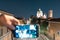 Night view with smartphone, of the dome of the Duomo Nuovo with movement of the city, Roman Catholic church and tower of the