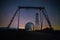 Night view. A special astrophysical observatory and a crane against the background of the starry sky and Caucasian mountains