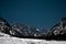 Night view of Tamar valley looking from Planica plateau toward majestic julian alps. View of stars at night above mountains