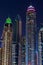 Night view to iconic skyscrapers skyline of Dubai Marina. Amazing illumination of the buildings.