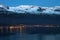 Night view to the small town and snowy mountains in the fjord of Iceland