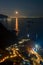 Night view from the top of the mountain to the Nerano bay. City lights. Coast of Amalfitana, Italy. Street houses and boats.