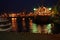 Night view of the tugboat in the cargo port of Odessa. Tugs and a floating crane are in port. Night panorama of the port