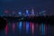 Night view on the Warsaw city buildings with lights reflection in the river.