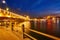 Night view at Yeni Cami Mosque worship place from Galata bridge reflected in water of Golden Horn of Bosporus