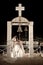 Night view of young newly wed couple under church bell archway