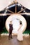 Night wedding ceremony outdoors. Bride and groom swear an oath each other on wedding arch background. Beautiful just