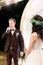 Night wedding ceremony outdoors. Bride and groom swear an oath each other on wedding arch background. Beautiful just