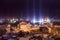 Night winter cityscape with light pillars atmospheric phenomenon
