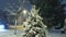 Night winter heavy snowfall a residential area with snow covered trees and driving cars by electric light.