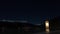 Night - winter time lapse of the Curon bell tower appearing from Resia Lake, South Tyrol, Italy