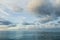 Nightfall over Caribbean sea. Deep ocean view with waves and white clouds. Relaxing seascape, endless sea, tropical waters