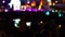 Nightlife concept. Silhouettes of concert crowd in front of defocused stage lights