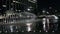 Nightly view of water fountains in downtown park with kids playing