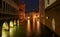 Nighttime cityscape of a canal in Venice