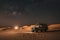 nighttime desert safari with a view of the stars and moon above