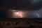 nighttime desert storm with lightning and thunder, bringing dramatic weather to the arid landscape