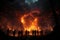Nighttime forest fire, people\\\'s silhouettes watching