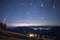 Nighttime Horizon with Meteors and Rolling Hills.