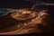 Nighttime long exposure of Viewpoint of twisted highway on Jebal Hafeet aka Jebel Hafit in Al Ain, UAE