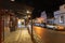 Nighttime in main street in heritage village street lights, and shop fronts lining both sides of road