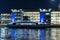 Nighttime photo of modern offices at Lindholmen, ferry arriving to the pier..