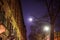 Nighttime shot of the moon, a street lamp, and building facade in Harlem, New York, NY, USA