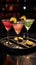 Nighttime Trio of Colorful Cocktails with Garnishes on Black Coaster