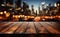 Nighttime urban scene Wooden table against blurred city building lights in darkness