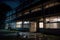 nighttime view of deserted hospital, with broken windows and shattered glass