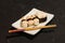 Nigiri Sushi set on white plate on black background. Japanese food. Asian tasty dinner.