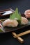 Nigiri sushi with shrimp and tuna fish on a gourmet platting on black background.