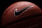 Nike brand, basketball ball Nike Baller. Orange rubber outdoor ball, ultra-durable cover, close-up on a black background