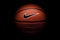 Nike brand, basketball ball Nike Baller. Orange rubber outdoor ball, ultra-durable cover, close-up on a black background