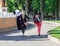 Nikolaev, Ukraine- June 6, 2020: young  girl carries a big soft  panda toy in her left hand. Her mom is walking next to her. Sunny