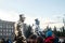 NIKOPOL, UKRAINE - 09/28/2021: Close-up of stilt walkers at the fair. Male acrobats dressed in shiny mirrored costumes. The