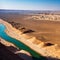 The Nile river landscape in Luxor, Upper Egypt, White motorboat on blue water wi...