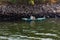 Nile river, near Aswan, February 16, 2017: fisherman paddling in a small boat in the dio, dressed in the typical Egyptian white an