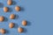 Nine brown eggs on a  blue background. The concept of minimalism to your design