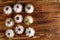 Nine cakes with protein cream and summer berries on wooden table.