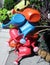 Nine colored plastic watering cans