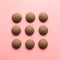 Nine cookies in row in pink background. Flat lay. Top view